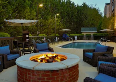 Outdoor fire pit and pool deck at Hampton Inn & Suites — Asheville Airport
