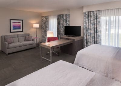 Guest room and sitting area at Hampton Inn & Suites — Biltmore Area