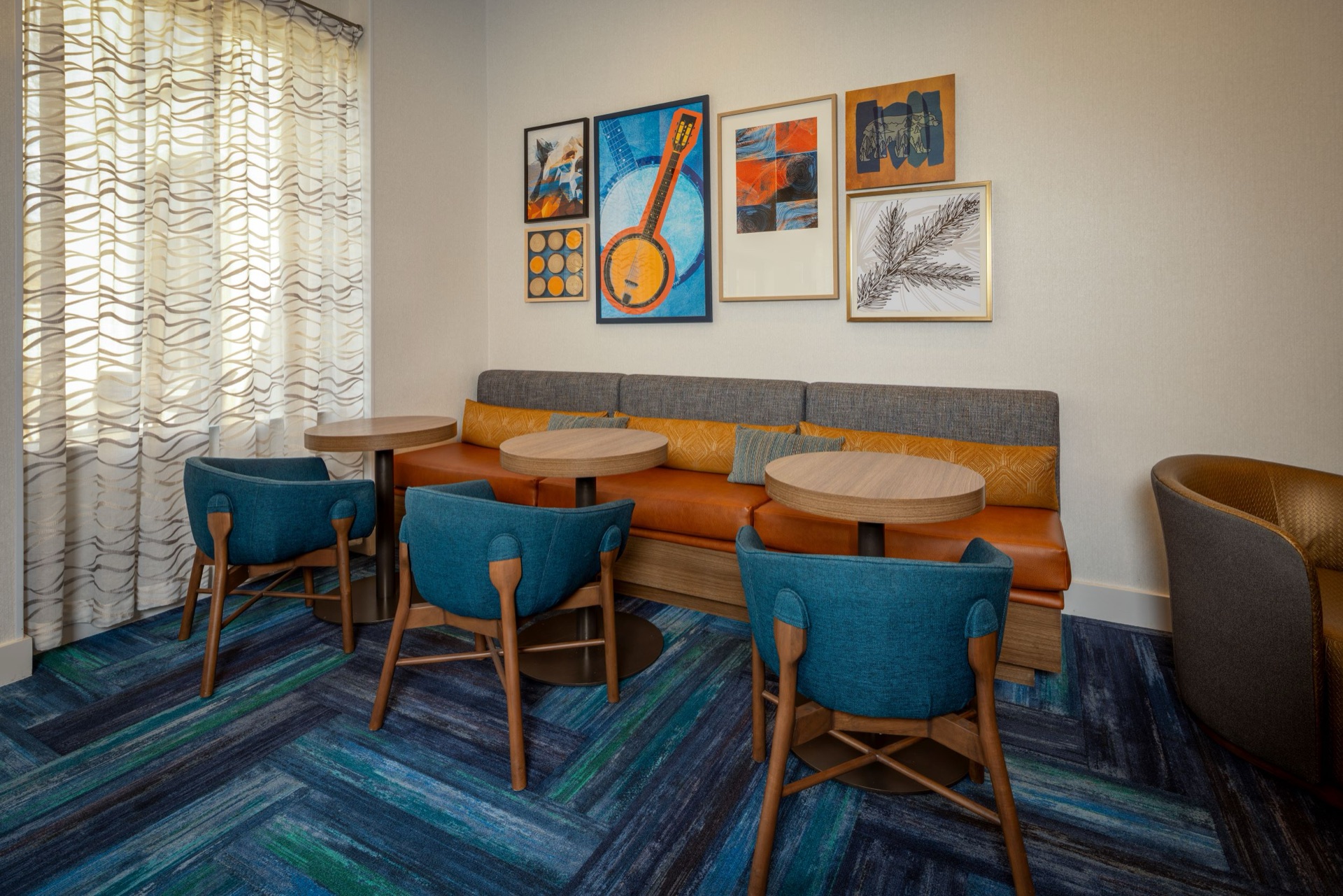 Lounge seating with local artwork at Homewood Suites by Hilton Asheville